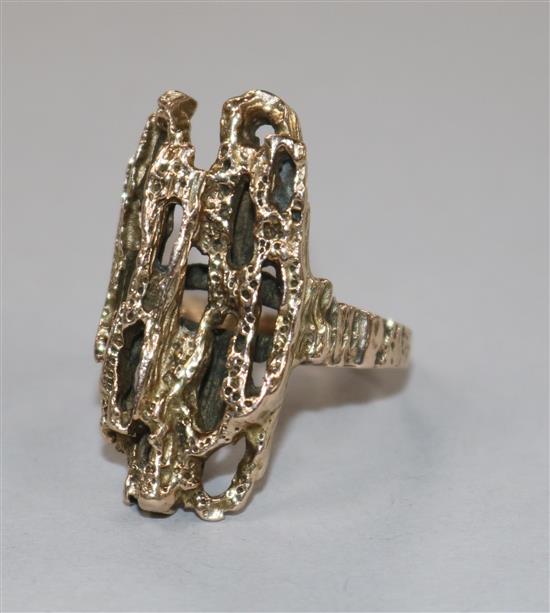 A late 1960s 9ct gold textured ring of rustic form, size L.